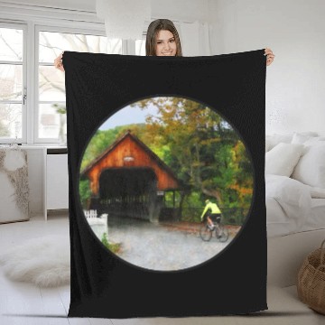 Discover Bicyclist racing toward Middle Bridge in Woodstock Fleece Blankets