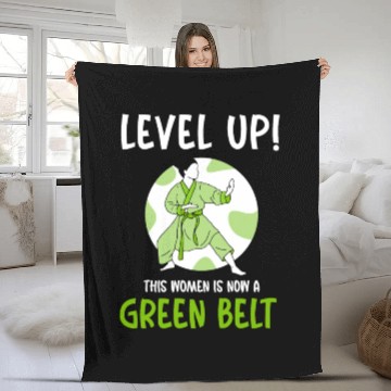 Discover Level Up! This women is now a green belt Fleece Blankets