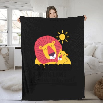 Discover Lion lying in the African sun Fleece Blankets