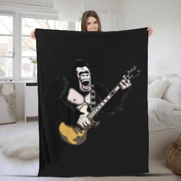 Discover Huge ape playing electric guitar. Fleece Blankets
