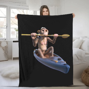Discover Monkey in a kayak Fleece Blankets