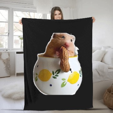 Discover Beautiful hamster Caramella holding a peanut Fleece Blankets