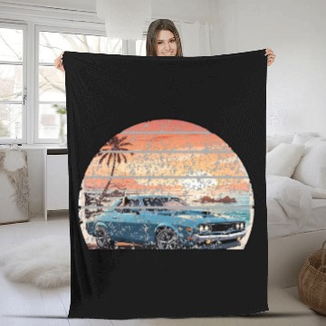 Discover A muscle car cruisingon a coastal road. Fleece Blankets