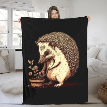 Discover A hedgehog as he does a bit of gardening, perhaps Fleece Blankets