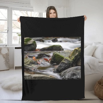 Discover Autumn water flowing over green moss boulders. Fleece Blankets