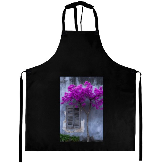 Vibrant Blossom Against Rustic Wall Aprons