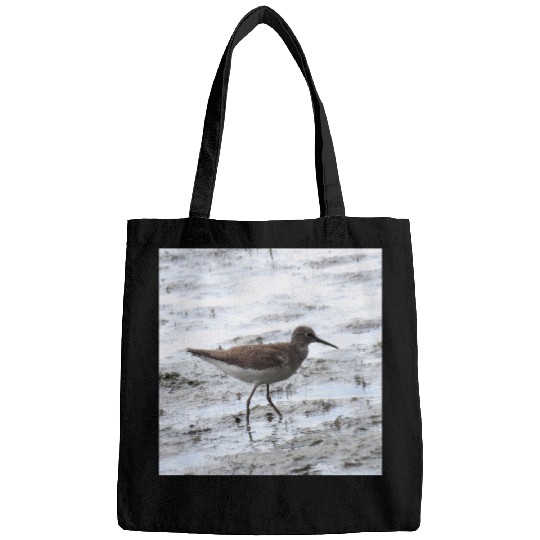 Sandpiper walking along the shore Bags