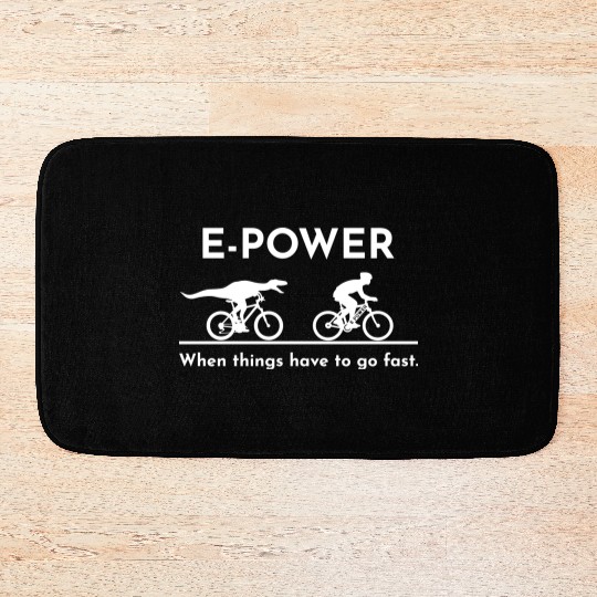 Velociraptor chasing e-biker Bath Mats