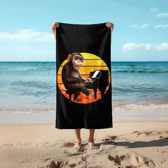 Monkey at the piano Beach Towels