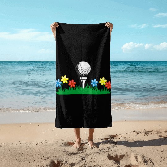 Golf ball on grass field with flowers Beach Towels