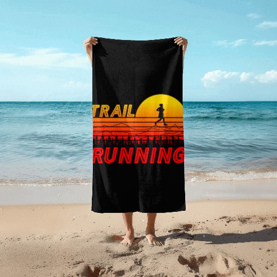 Trail running in orange sunset with mountains Beach Towels