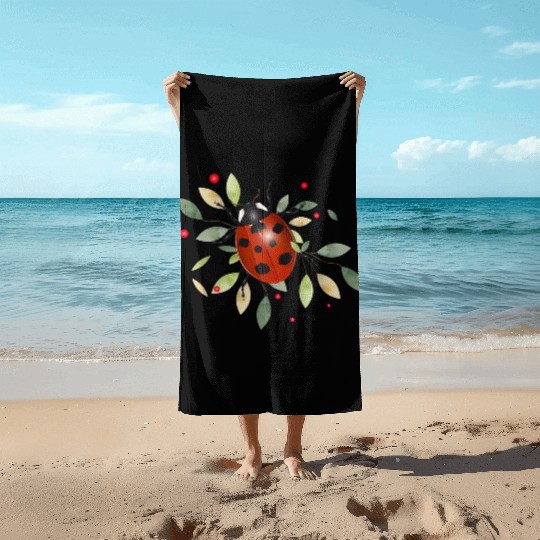 red glowing ladybug with green leaves Beach Towels