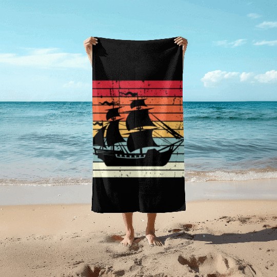 Pirate ship sunset Beach Towels
