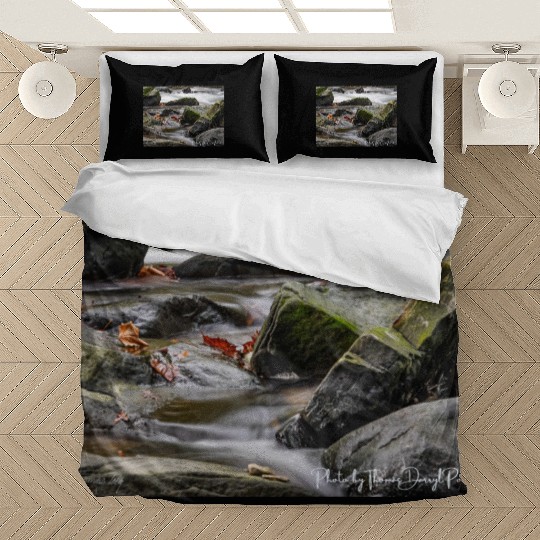 Autumn water flowing over green moss boulders. Bedding Sets