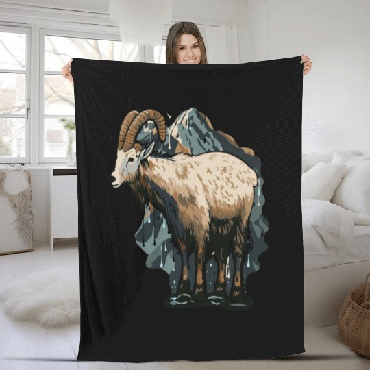 a mountain goat lives in the mountains Fleece Blankets