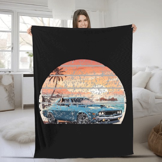 A muscle car cruisingon a coastal road. Fleece Blankets