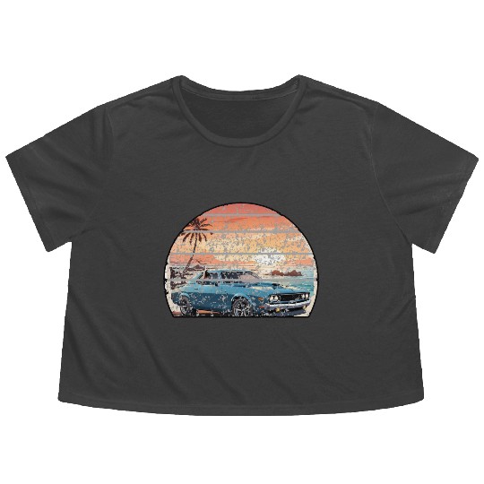 A muscle car cruisingon a coastal road. Flowy Cropped Tees