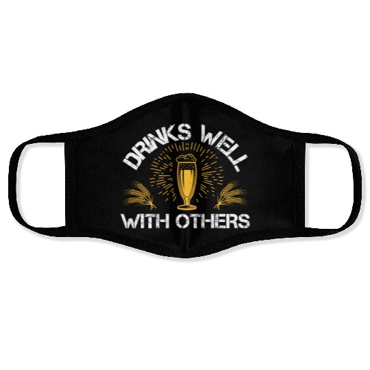 Drinks well with others Face Masks