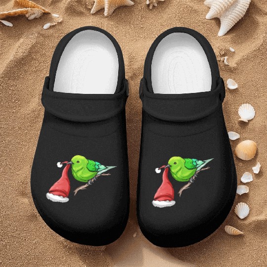 Little Green Bird Carrying Santas Hat In Beak On Nurse Clogs
