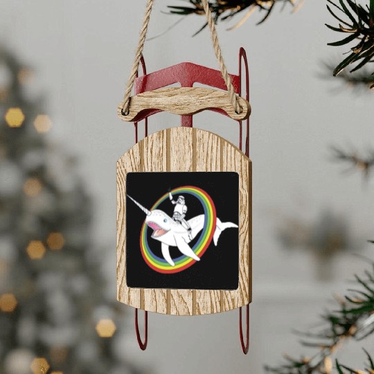 Spaceman riding narwhal through rainbow Sled Ornaments