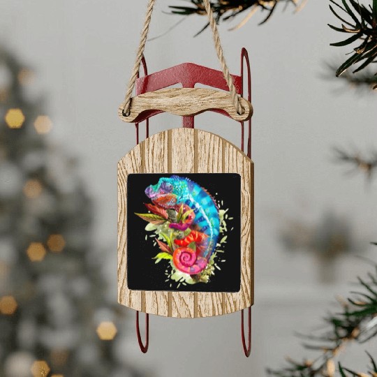 A chameleon is sitting on a branch 11 1 Sled Ornaments
