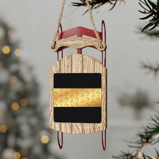 Christmas candy canes on a golden imitation backgr Sled Ornaments