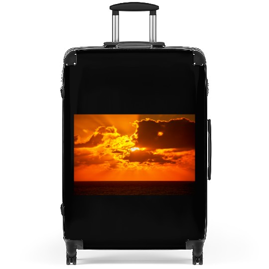 brilliant shining sun behind clouds rises Suitcases