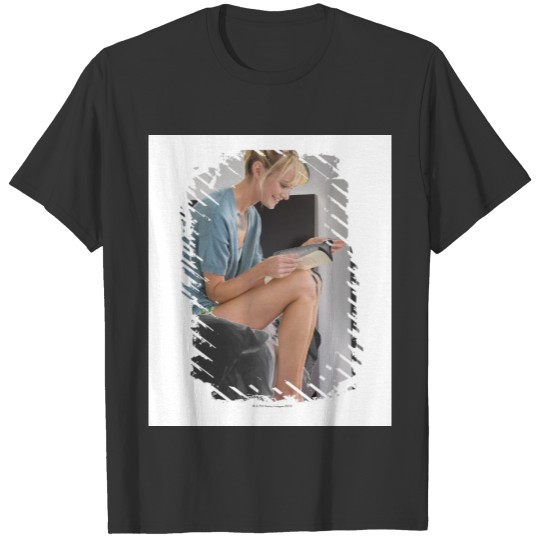 Woman reading a book on the bed T-shirt