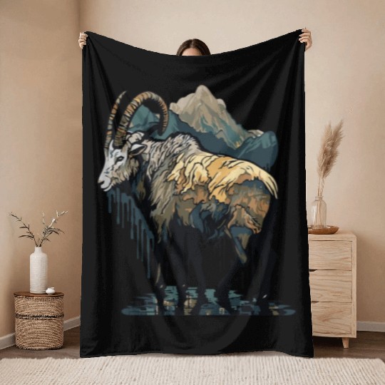 a mountain goat lives in the mountains Throw Blankets