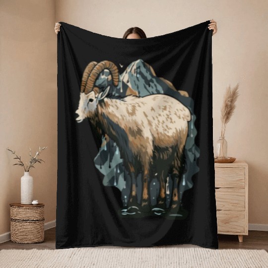 a mountain goat lives in the mountains Throw Blankets