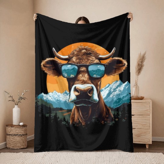A cow with sunglasses in the mountains Throw Blankets