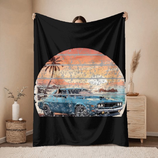 A muscle car cruisingon a coastal road. Throw Blankets