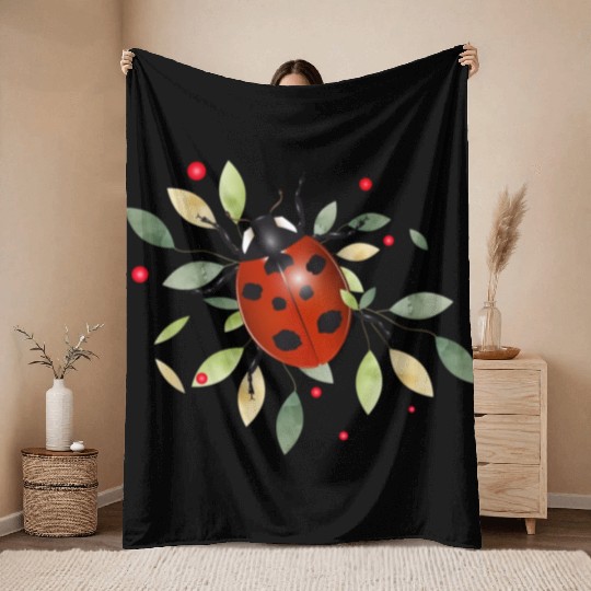 red glowing ladybug with green leaves Throw Blankets