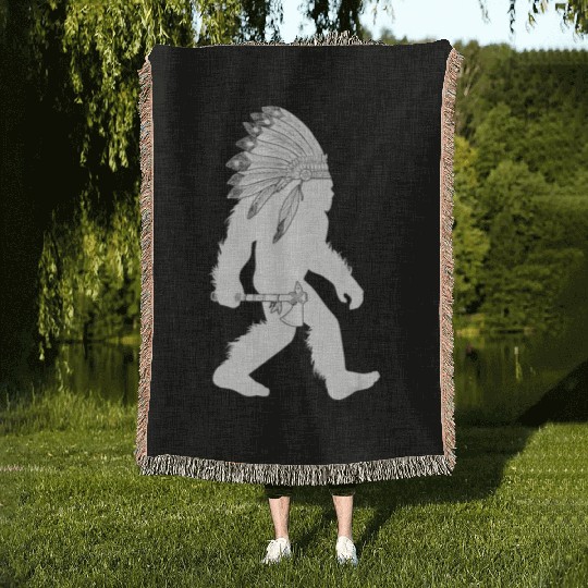 native american bigfoot wearing head holding Woven Blankets