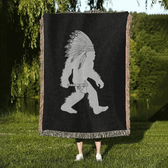 native american bigfoot wearing head holding Woven Blankets
