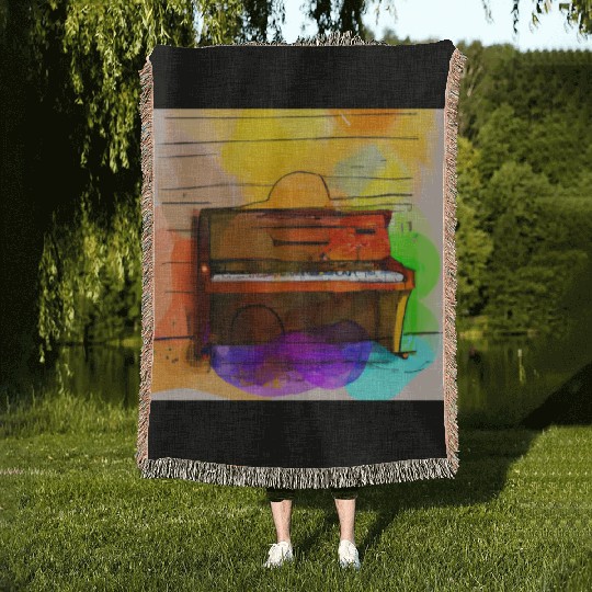 A beautiful piano in front of a colorful wall Woven Blankets