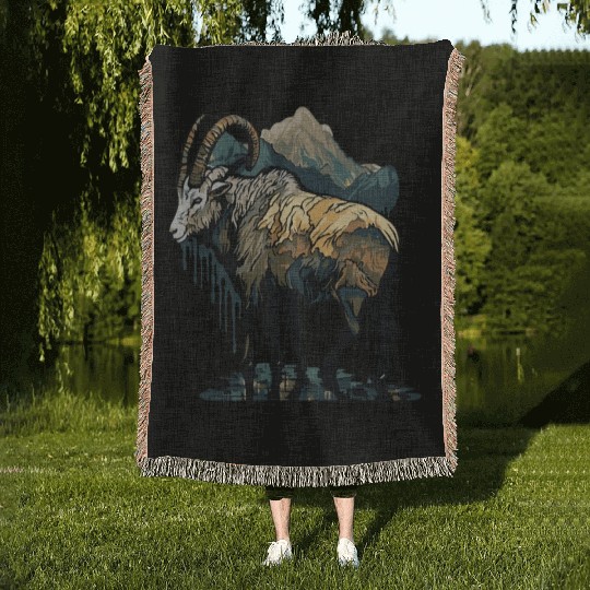a mountain goat lives in the mountains Woven Blankets