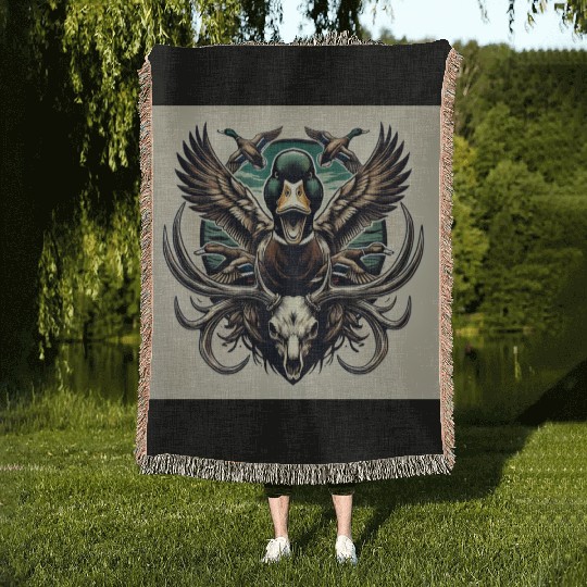 Mallard duck flying over deer skull in marsh Woven Blankets