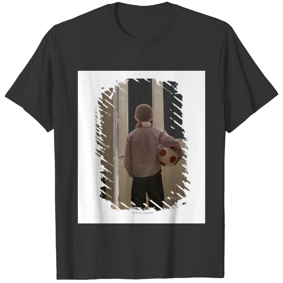 Boy in foyer with soccer ball T-shirt